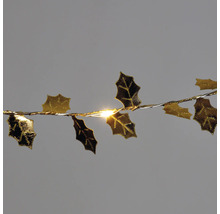 Guirlande lumineuse avec feuilles de houx comme décoration
