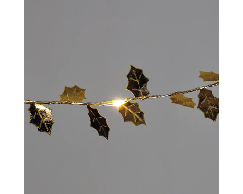 Guirlande lumineuse avec feuilles de houx comme décoration