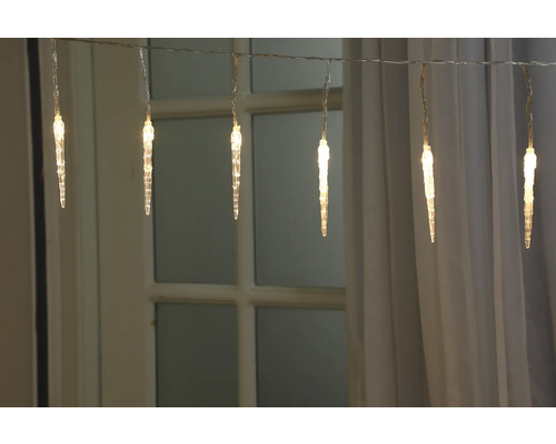 Guirlande lumineuse glaçons devant une fenêtre