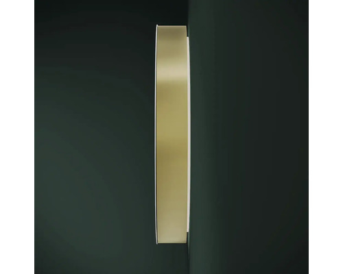 Miroir rond avec cadre en métal au mur