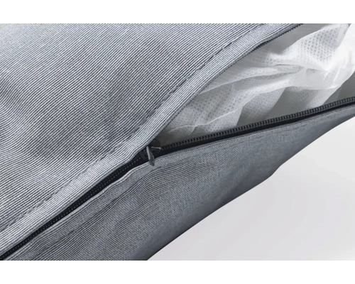 Gros plan d''un coussin gris avec fermeture éclair