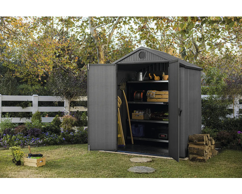 Scène de jardin avec remise à outils ouverte avec des étagères et des outils de jardin
