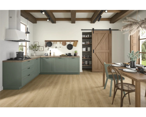 Helle und geräumige Wohnküche mit grünen Küchenschränken, Holzbalkendecke und Holzboden.