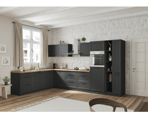 Cuisine moderne avec armoires foncées, plan de travail en bois et four