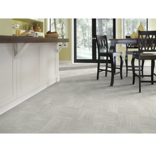 Heller Raum mit Bodenfliesen in quadratischer Anordnung und Kücheninsel mit Barhockern