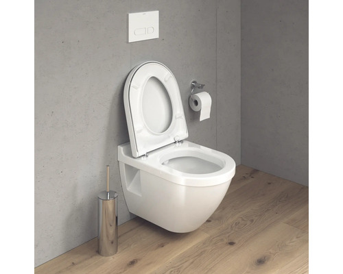 Wandhängendes WC mit offenem Toilettendeckel, Spülkasten und Toilettenpapierhalter im Badezimmer.