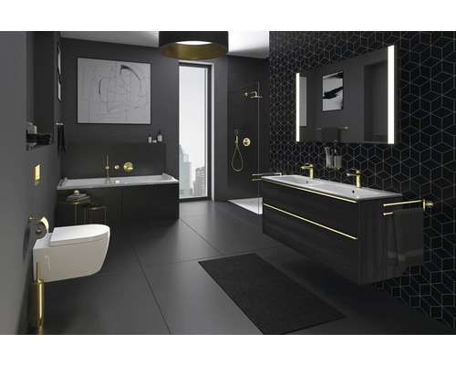 Salle de bains moderne avec baignoire, douche, lavabo et toilettes dans des tons sombres.