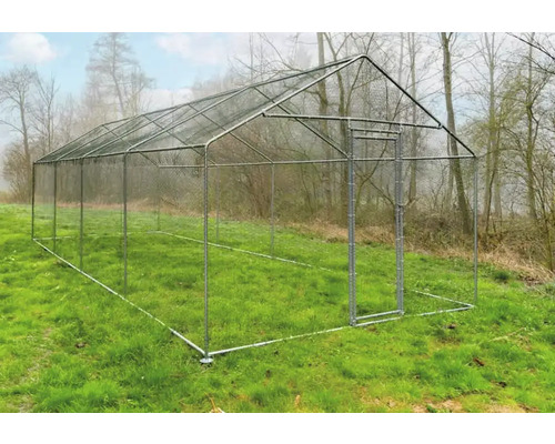 Volière autoportante en métal avec porte sur une prairie.