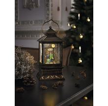 Lanterne décorative avec boule à neige et couple de figurines sur une table avec décoration de Noël