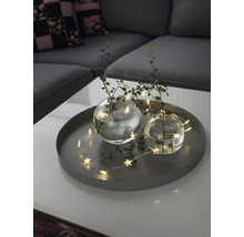 Plateau décoratif avec deux vases en verre, des brindilles et une guirlande lumineuse avec des étoiles