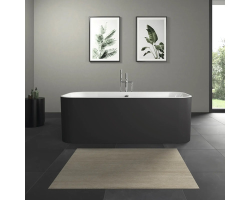 Baignoire îlot dans une salle de bains avec des tableaux de plantes au mur