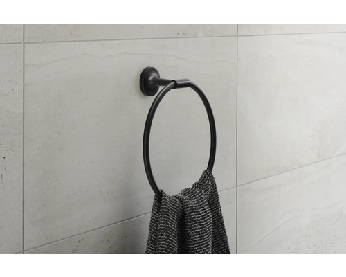 Porte-serviettes rond sur un mur avec une serviette