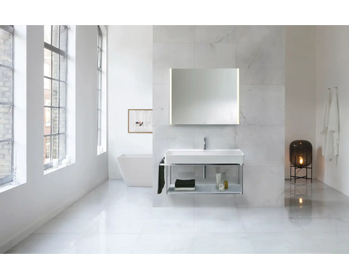Salle de bains avec lavabo, miroir, baignoire et lampe dans un design lumineux