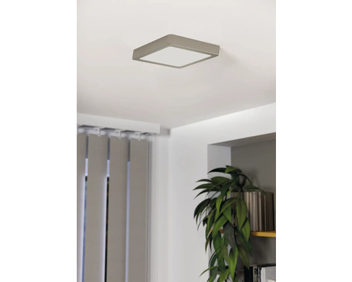 Plafonnier carré dans une pièce lumineuse avec des stores et une plante en pot.