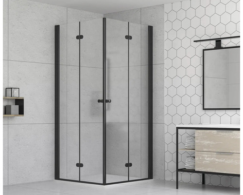 Douche d''angle avec cadre noir dans une salle de bain claire.