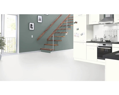 Pièce lumineuse avec escalier, porte donnant sur un balcon et kitchenette