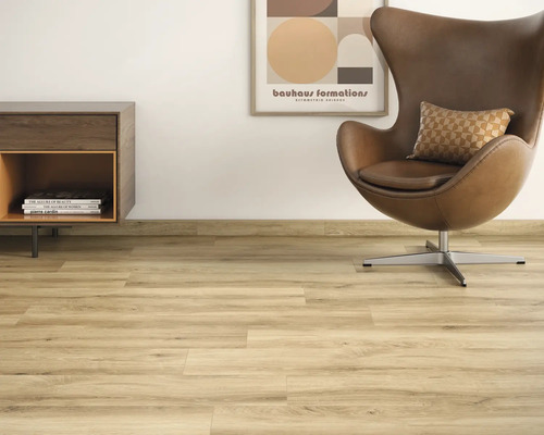 Salon lumineux avec sol stratifié, fauteuil et commode