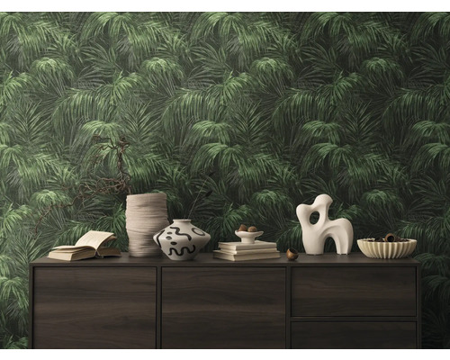 Gros plan d''un mur avec un papier peint à motif de feuilles créant une ambiance tropicale