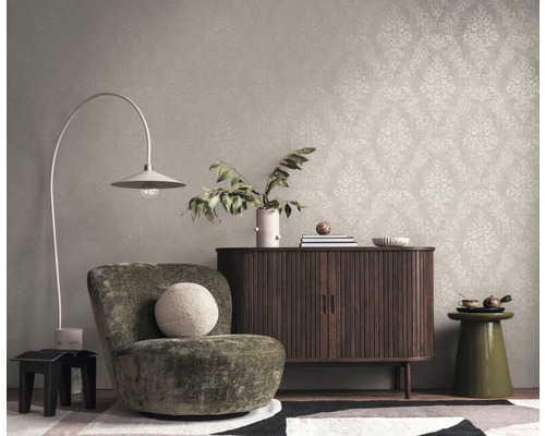 Interieur mit Ohrensessel, Kommode und gemusterter Tapete