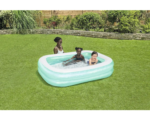 Piscine gonflable avec des enfants qui jouent dans le jardin.