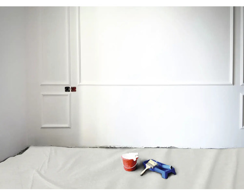 Pièce avec bacs à peinture, pot de peinture, pinceau et sol recouvert pour la peinture des murs