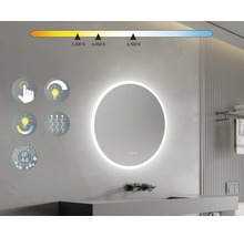 Runder Spiegel mit LED-Beleuchtung an einer Badezimmerwand mit Waschbecken und Armatur sowie Symbolen für Funktionen.