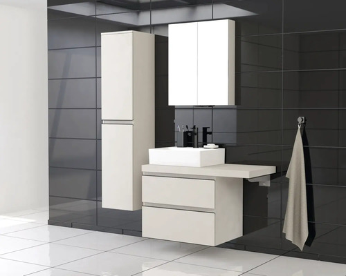Salle de bains moderne avec lavabo, armoire de toilette et armoire haute sur fond de carrelage foncé.