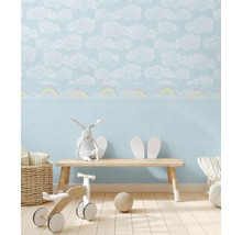 Chambre d''enfant avec papier peint nuages et arc-en-ciel, banc en bois et jouets