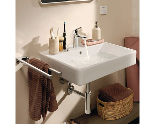 Badezimmerwaschtisch mit Armatur, Handtuchhalter und Accessoires für die Badgestaltung.