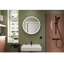 Salle de bains avec lavabo, miroir rond et douche