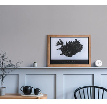 Dekoratives Zimmer mit Islandkarte im Rahmen, Teekanne und Pflanze