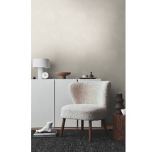 Wohnzimmer mit Struktur Tapete, Sessel, Kommode und Dekoration