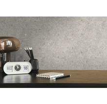 Nahaufnahme einer grauen Mustertapete mit einem Schreibtisch und Accessoires