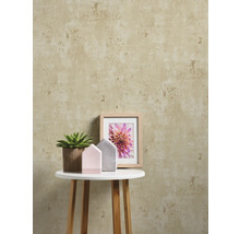 Dekorative Wand mit Muster, Beistelltisch mit Zimmerpflanze, Häusern und Bilderrahmen