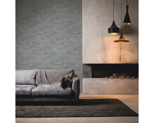 Wohnzimmer mit grauer Couch, Decke, gemusterter Tapete, Kamin und Hängelampen