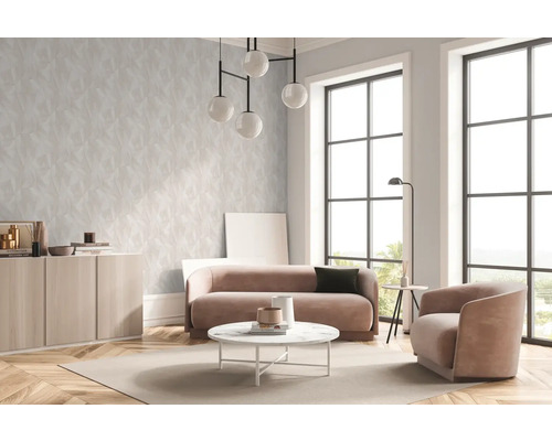 Salon lumineux avec papier peint à motifs, canapé, fauteuil et grande fenêtre