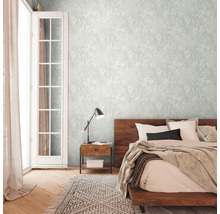 Chambre à coucher avec papier peint à motifs floraux, lit, table de chevet, lampe et tapis