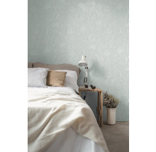 Schlafzimmer mit Bett und floral gemusterter Tapete