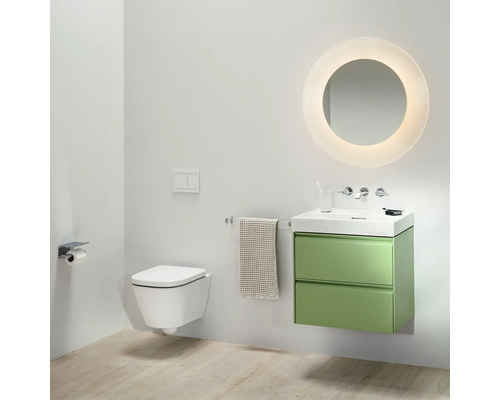 Salle de bains moderne avec WC suspendu, meuble sous-lavabo vert et miroir rond avec éclairage