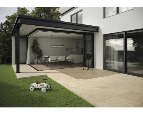 Terrasse moderne avec barbecue, dalles de terrasse et porte de terrasse ouverte sur une salle à manger.