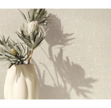 Dekorative Pflanze in einer Vase vor einer strukturierten Wand