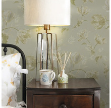 Table de chevet avec lampe, tasse et flacon d''huile parfumée dans une chambre lumineuse