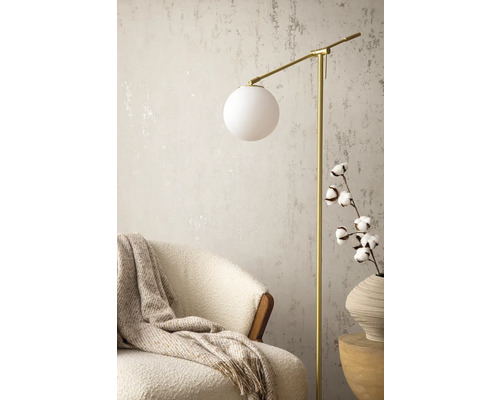 Scène avec lampadaire, fauteuil, couverture en laine et branche de coton dans un vase