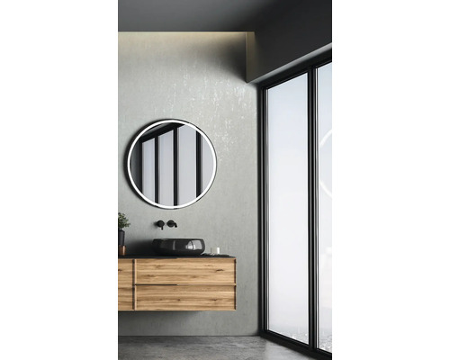 Badezimmer mit Waschtischunterschrank, rundem Spiegel und Fenster