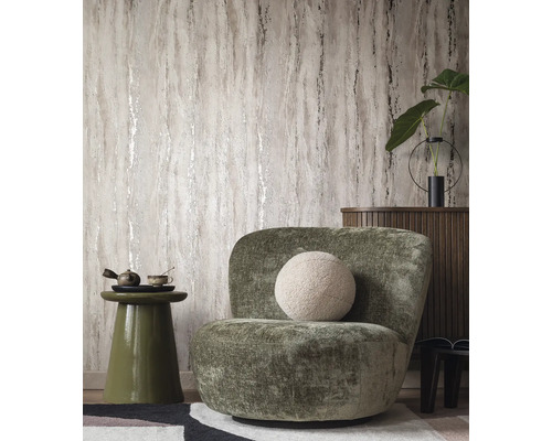 Salon avec papier peint à motifs, fauteuil et table d''appoint.