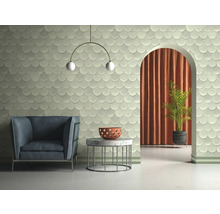 Helles Zimmer mit Sessel, Tisch, Zimmerpflanze und Wandfliesen in Schuppenoptik