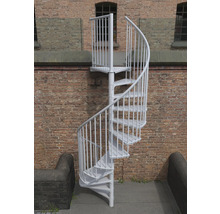 Freistehende Wendeltreppe aus Metall vor einer Ziegelwand