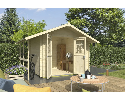 Abri de jardin avec portes ouvertes sur une terrasse avec mobilier de jardin et un vélo