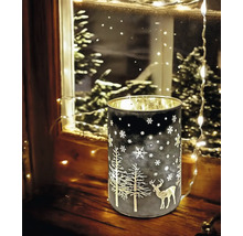 Photophore décoratif avec motifs de sapins et de cerfs pour une ambiance chaleureuse.