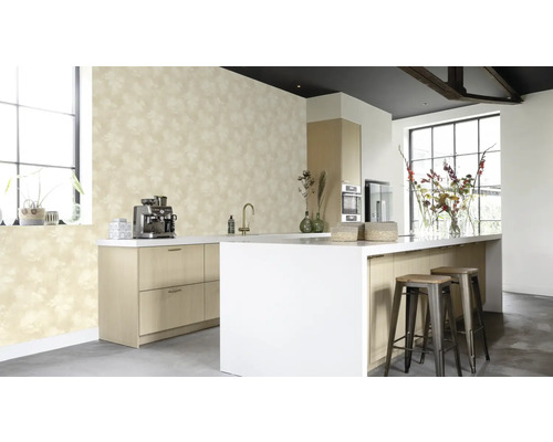 Cuisine claire avec papier peint à motifs, îlot de cuisine et tabourets de bar.